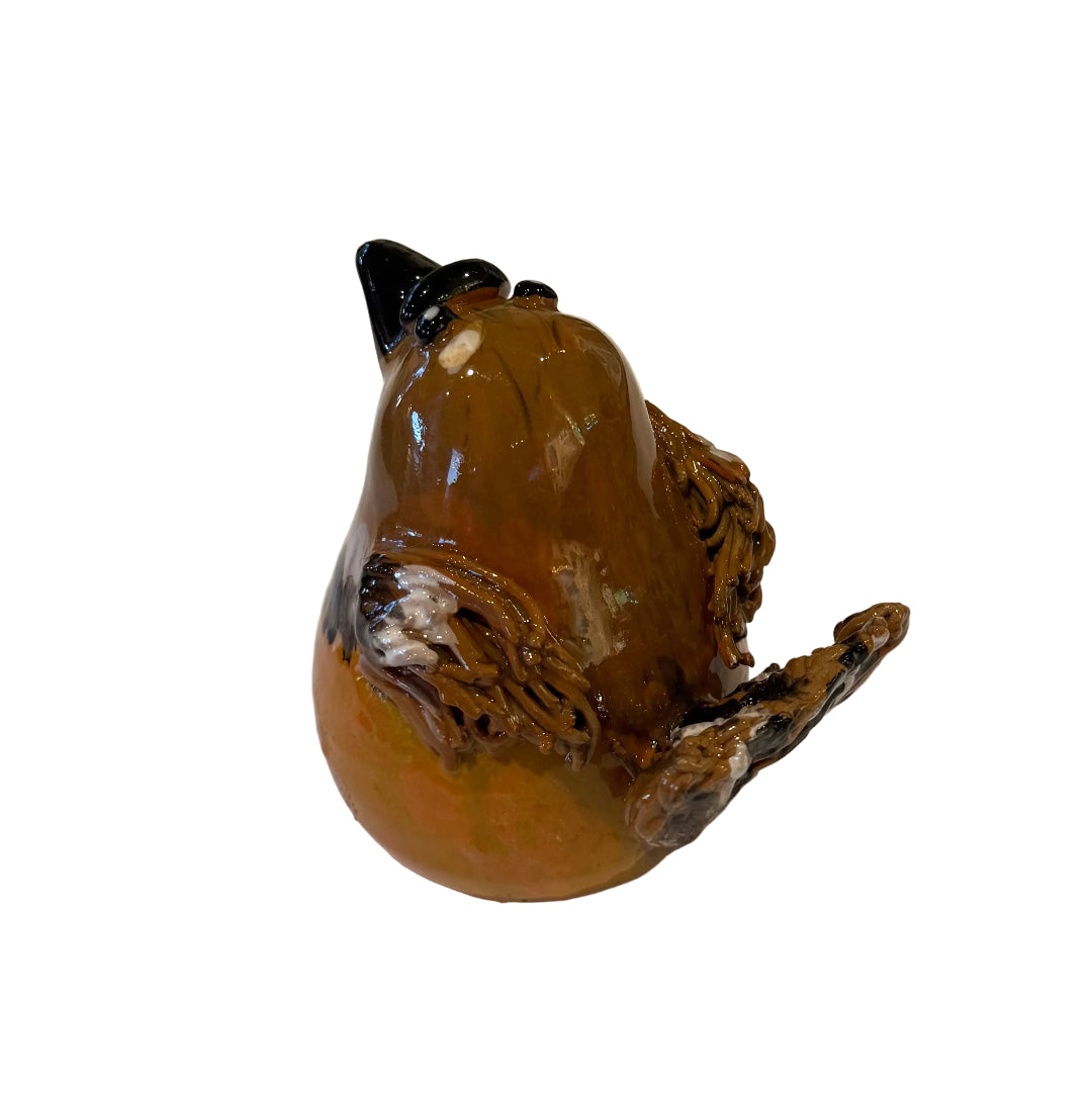 Side view of a ceramic Fantail sculpture with a black beak on a white background