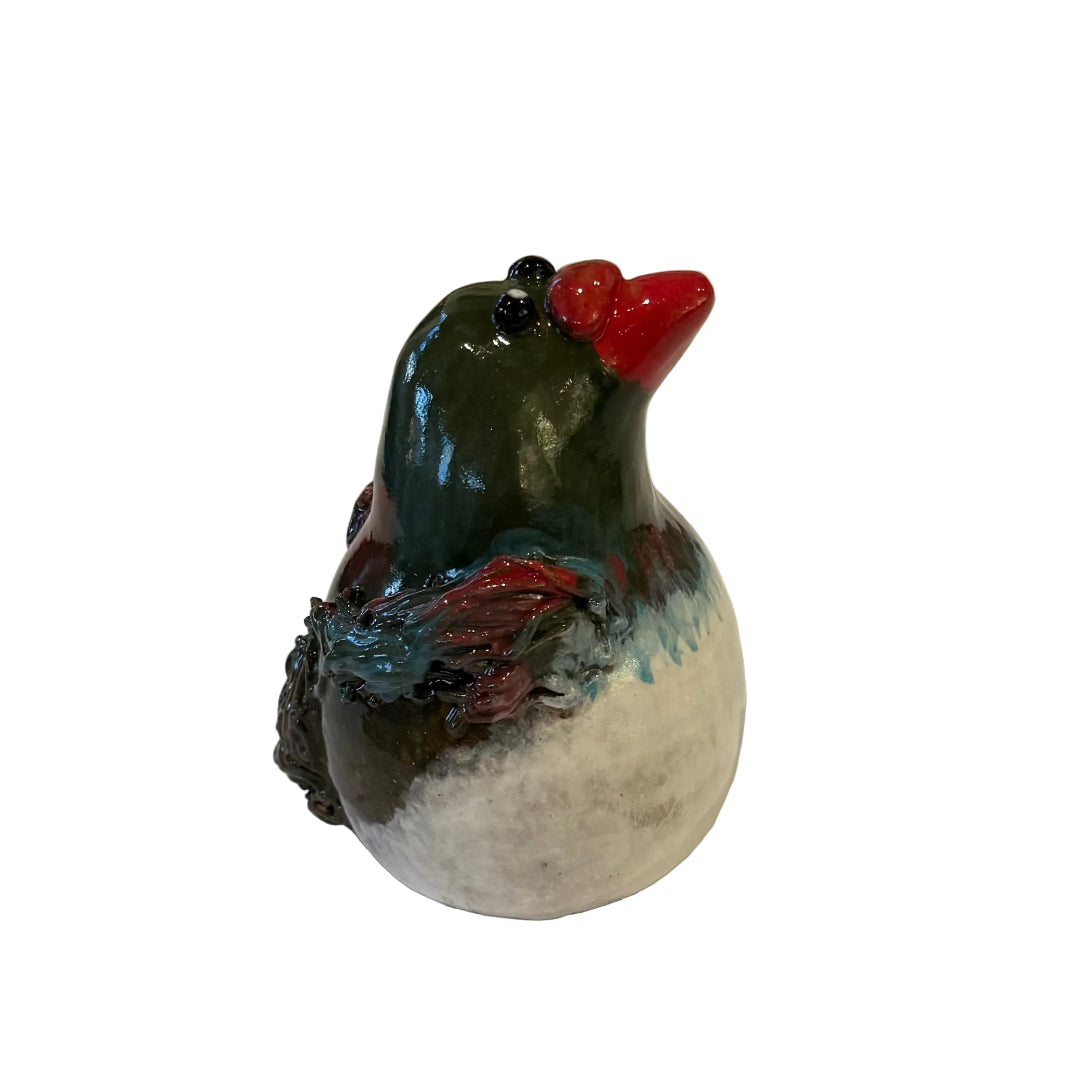 Ceramic Kereru bird sculpture with a red beak on a white background