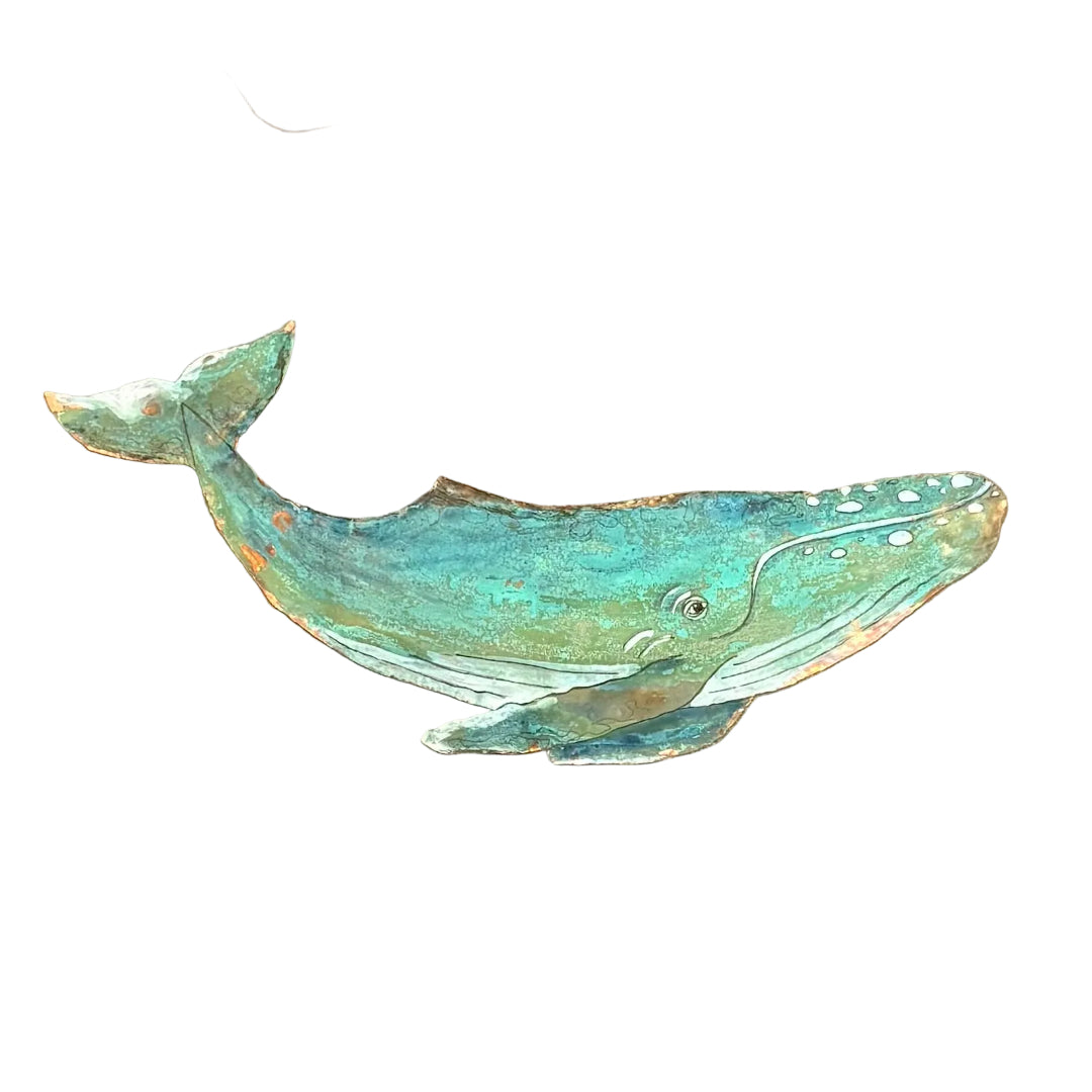 A hand-painted copper whale wall hanging in distressed teal, green, and white tones, displayed on a white surface.