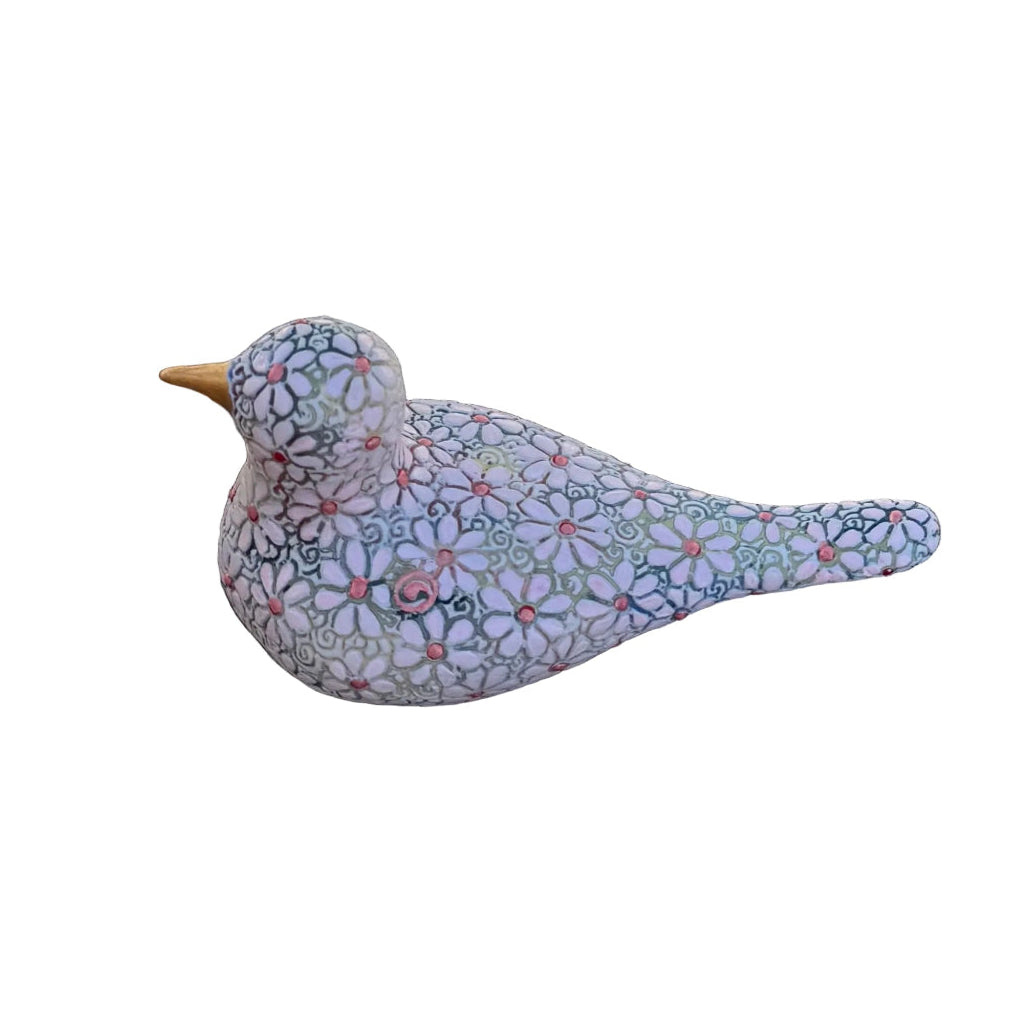 A decorative bird figurine with a colorful floral mosaic pattern on a white base, resting on white background.