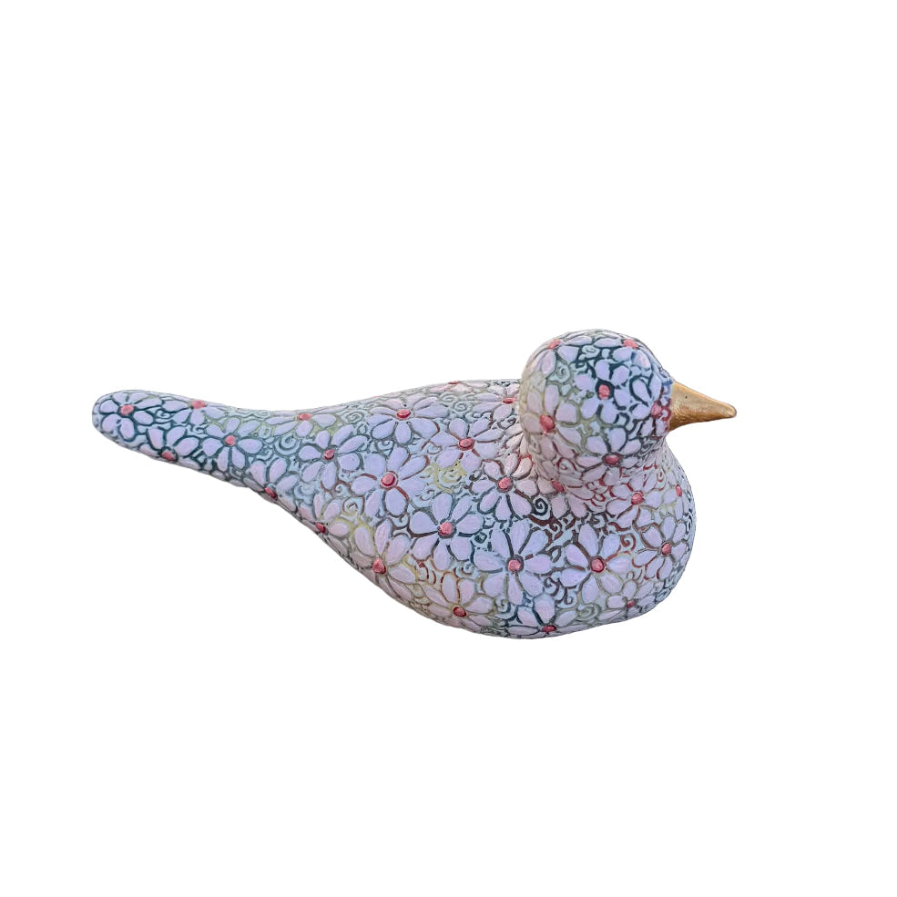 A decorative bird figurine with a light lavender-pink base covered in a dense, multicolored floral and geometric pattern, featuring a small gold-toned beak.