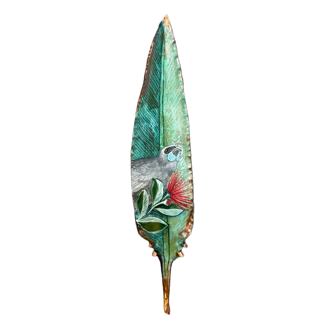 Copper feather wall art sculpture hand painted with a Kokako bird on Pohutakawa flowers against a white background.