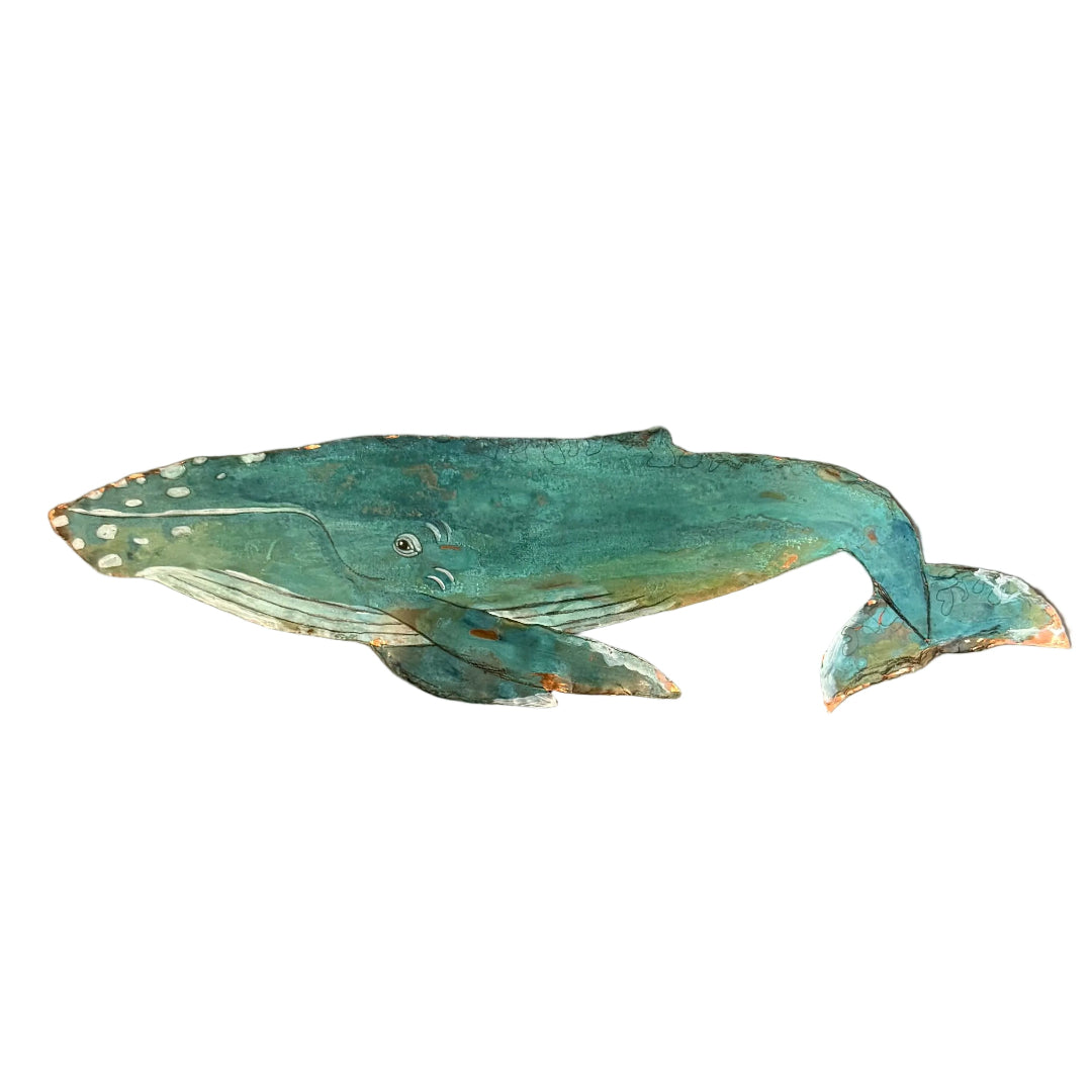 A hand-painted copper whale wall hanging in distressed teal, green, and white tones, displayed on a white surface.
