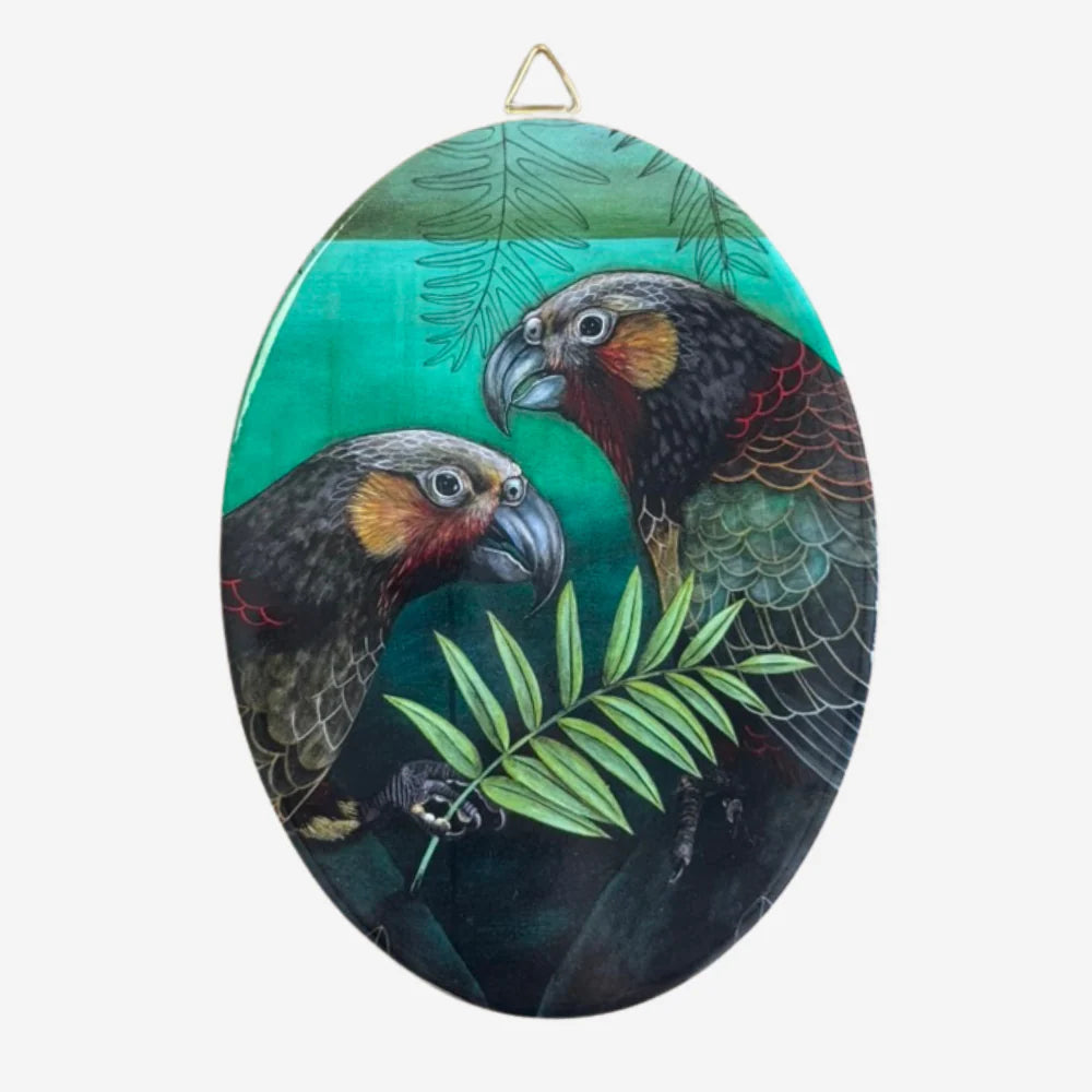 Oval-shaped painting of two parrots with a green background