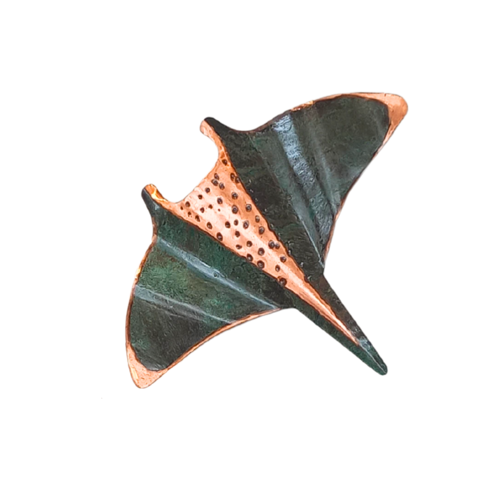 Copper wall manta ray with copper and green patina on a white background