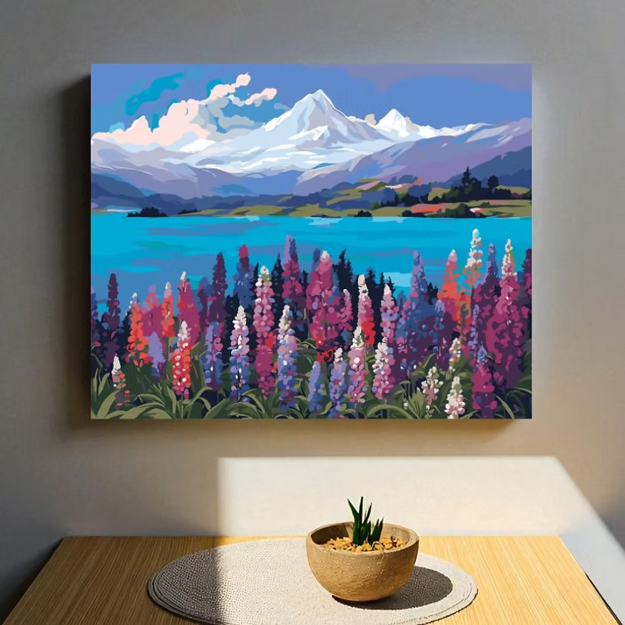 Painting of a mountain landscape with flowers on a wall above a table.