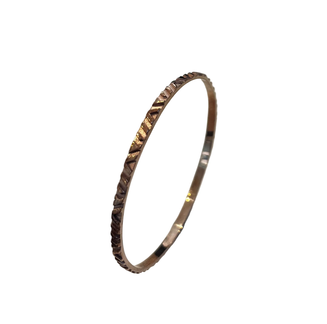Copper bangle on a white gray background