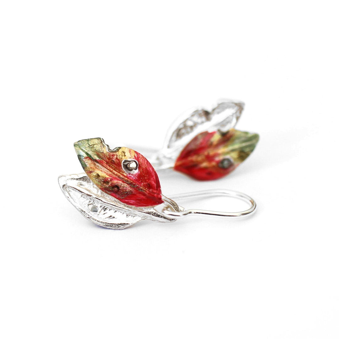 Colourful hand painted sterling silver earrings on white background