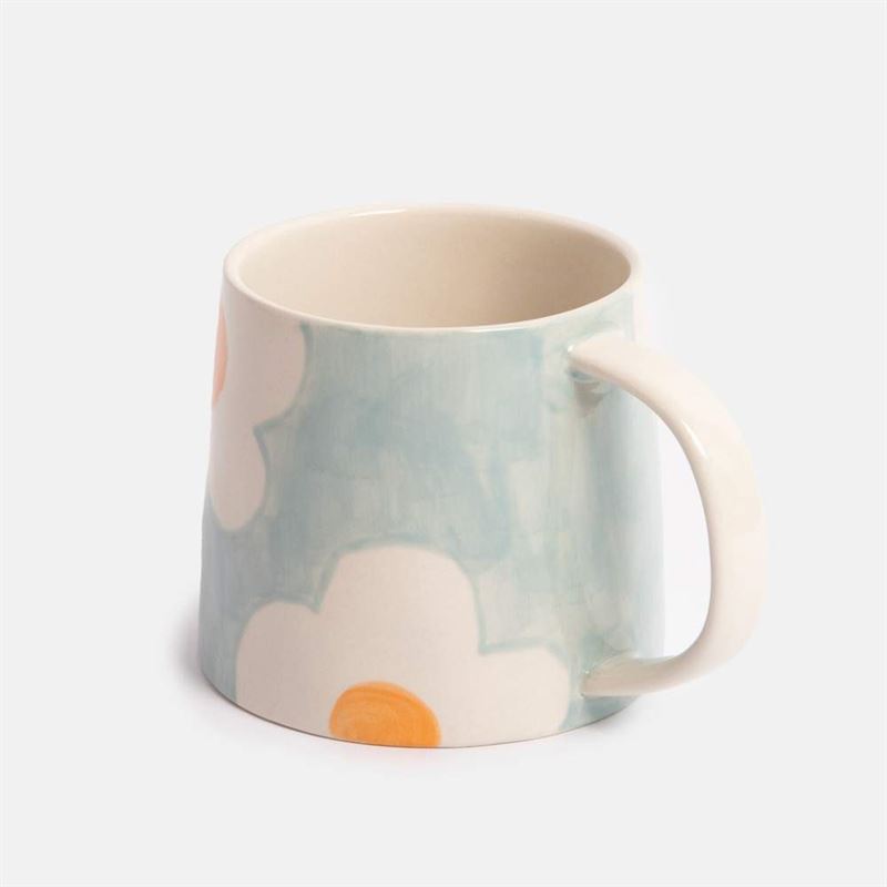 Blue mug with floral pattern on a white background