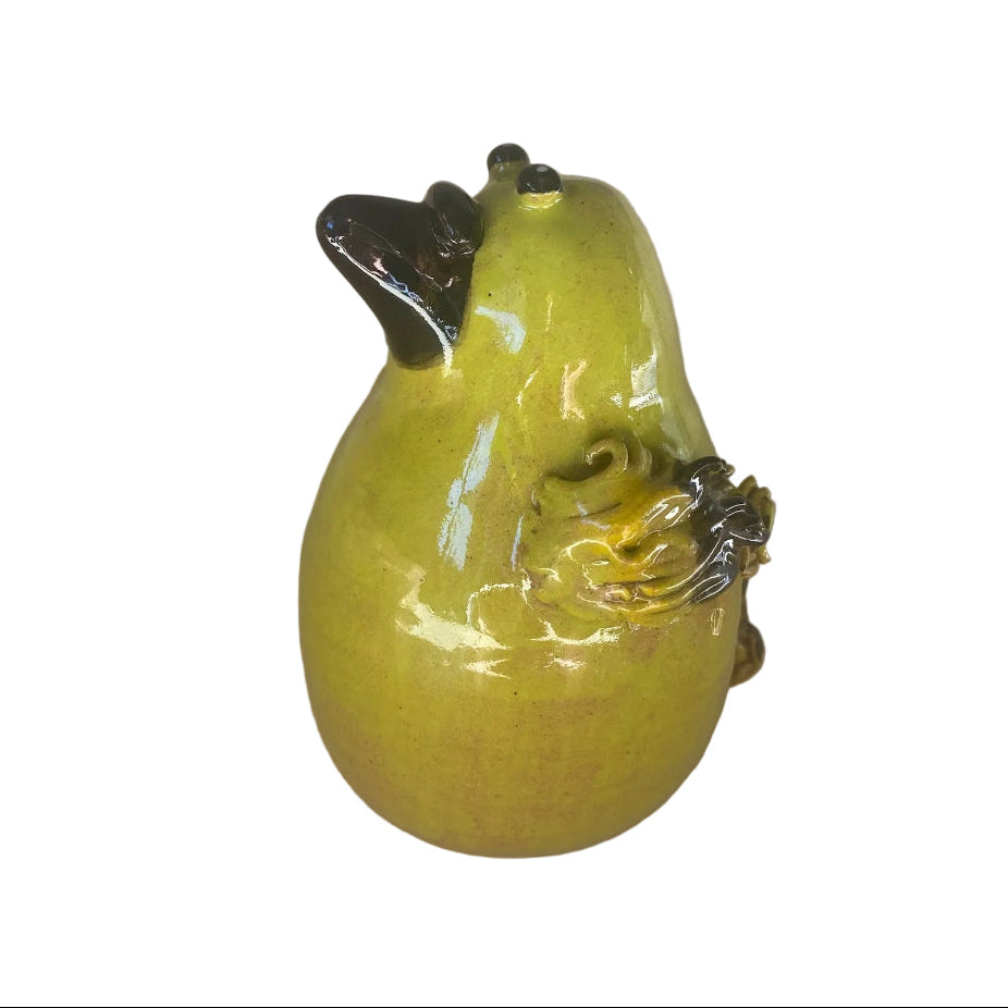 Ceramic Bellbird sculpture with a black beak on a white background