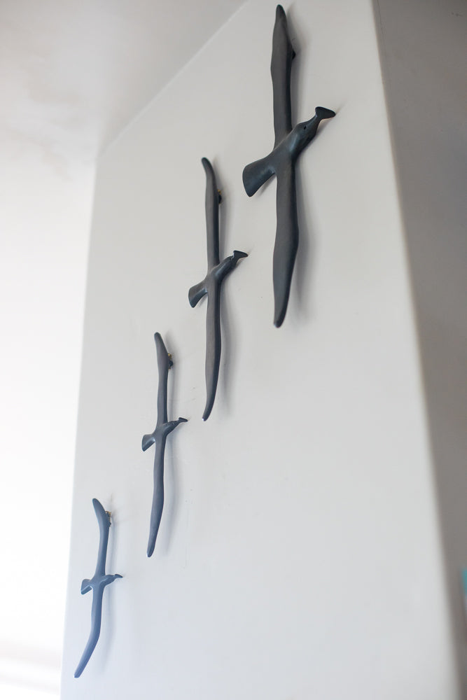 Decorative wall art of stylized birds on a white wall