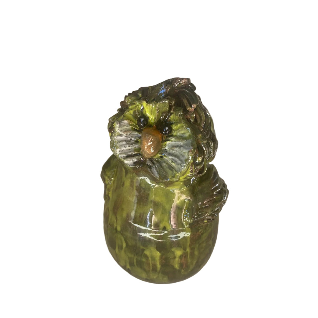 Ceramic Kakapo bird sculpture with an orange beak on a white background