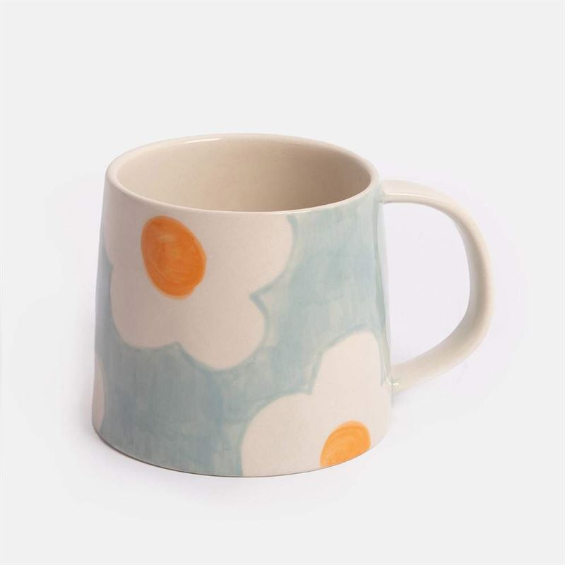 Blue mug with floral pattern on a white background