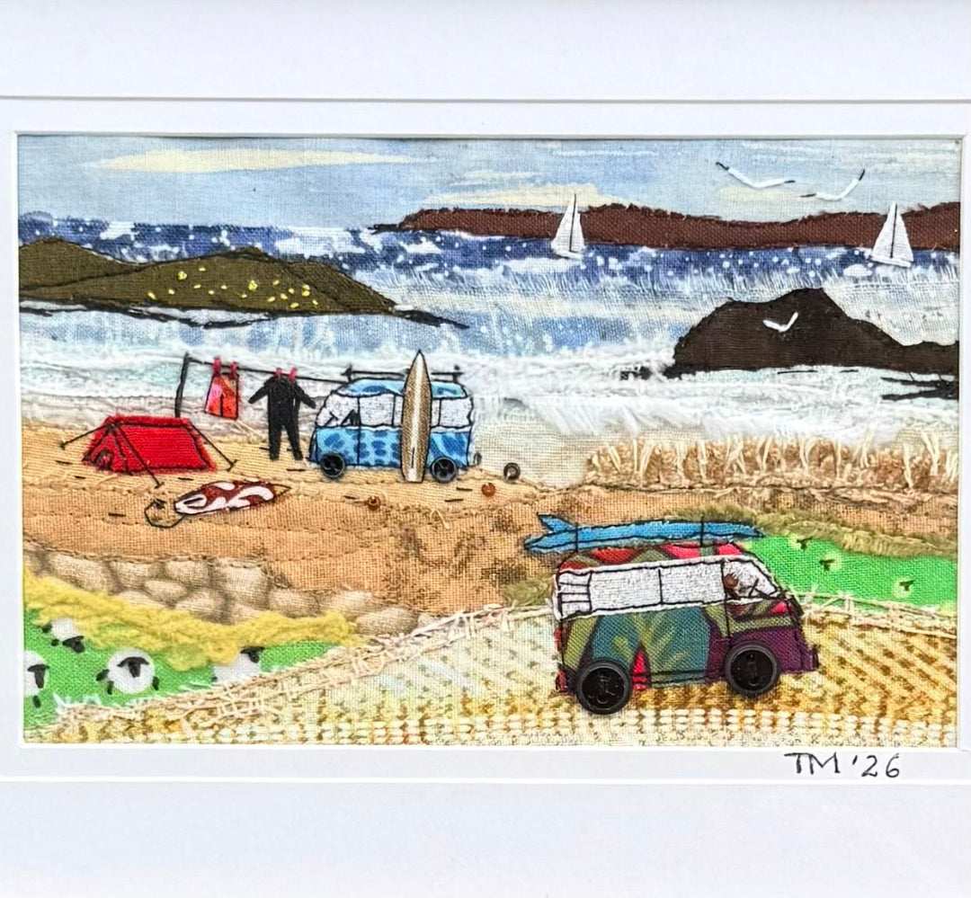 Textile artwork showing 2 vans at the beach.