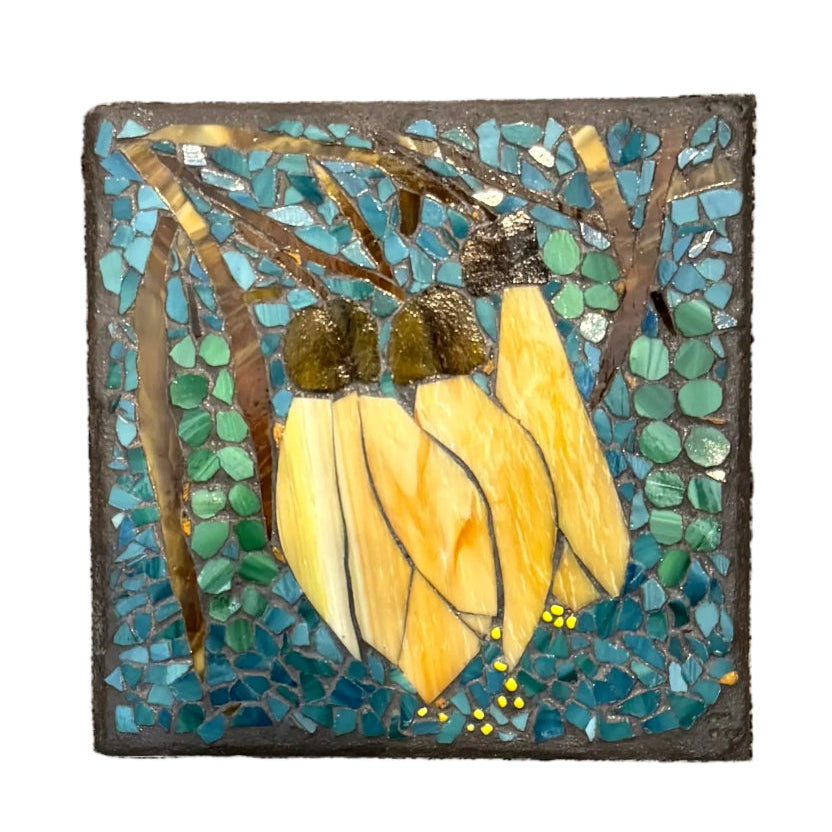 Glass Mosaic Yellow Kowhai Flower On A Ceramic Wall Tile On A White background.