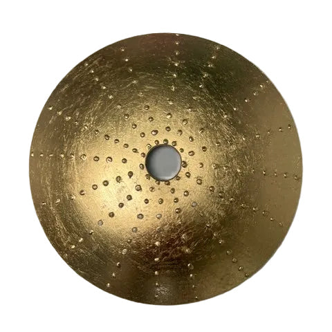 Gold decorative plate with a central hole on a gray background