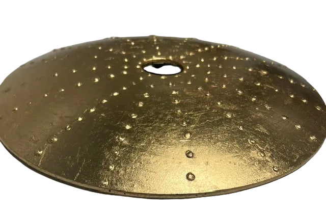 Gold circular glass disc on a white background