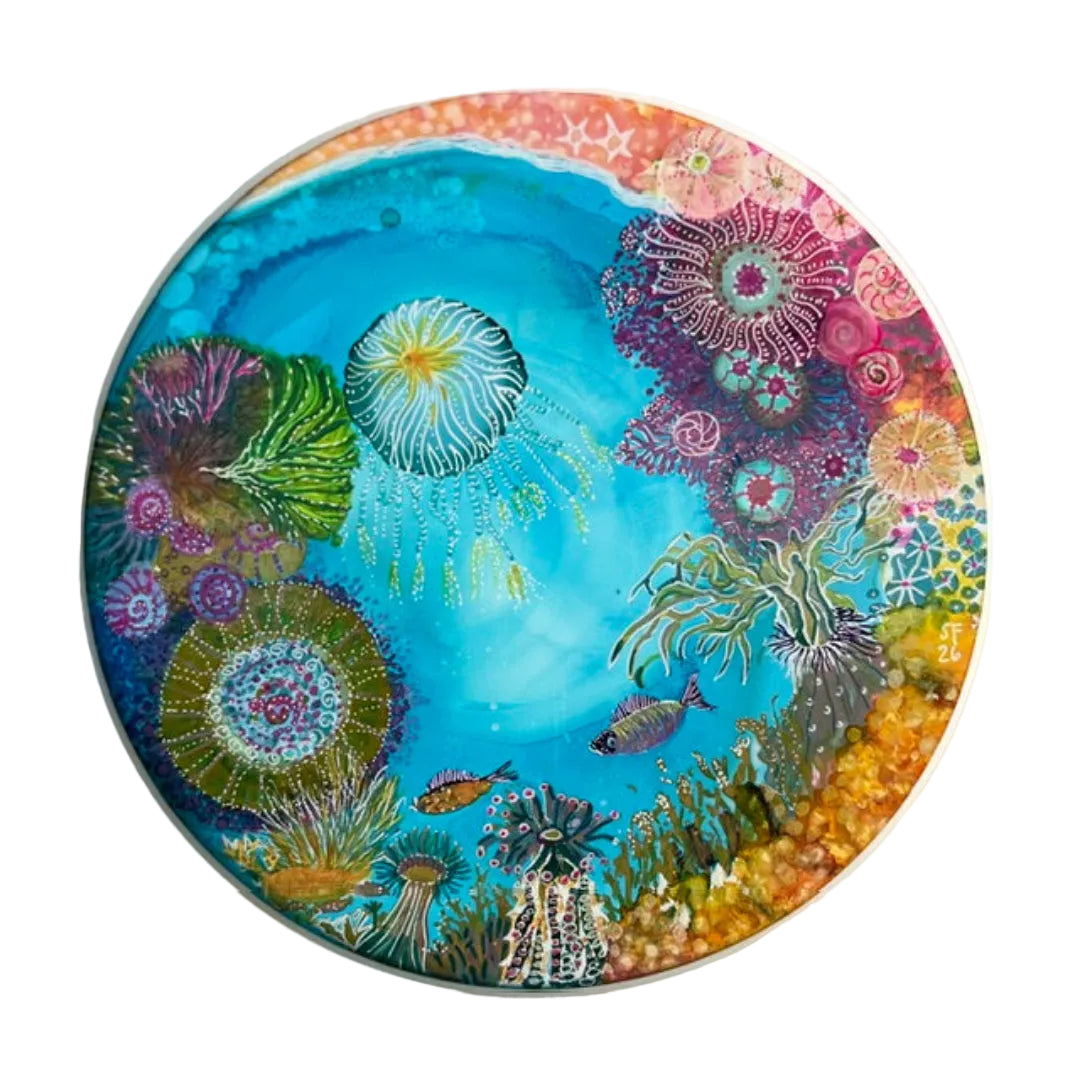 Colorful underwater scene with marine life on a circular plate.