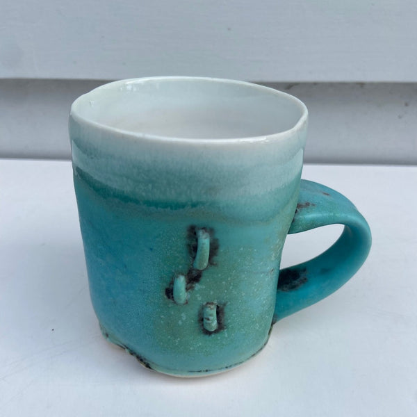 Turquoise Cup with X and 3 Staples