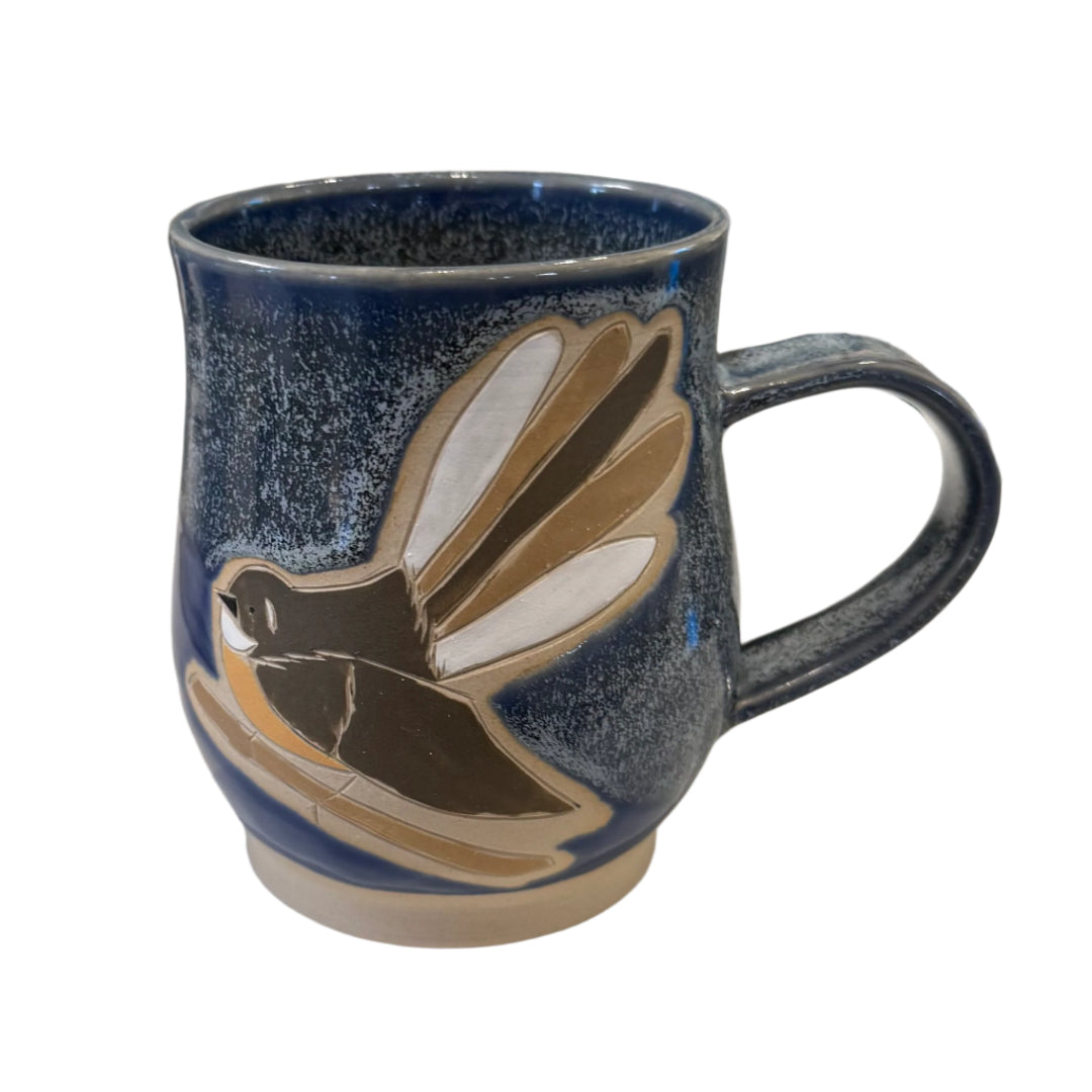 Blue Ceramic mug with a Fantail bird design on a white background