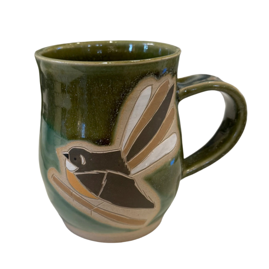 Green Ceramic mug with a Fantail bird design on a white background