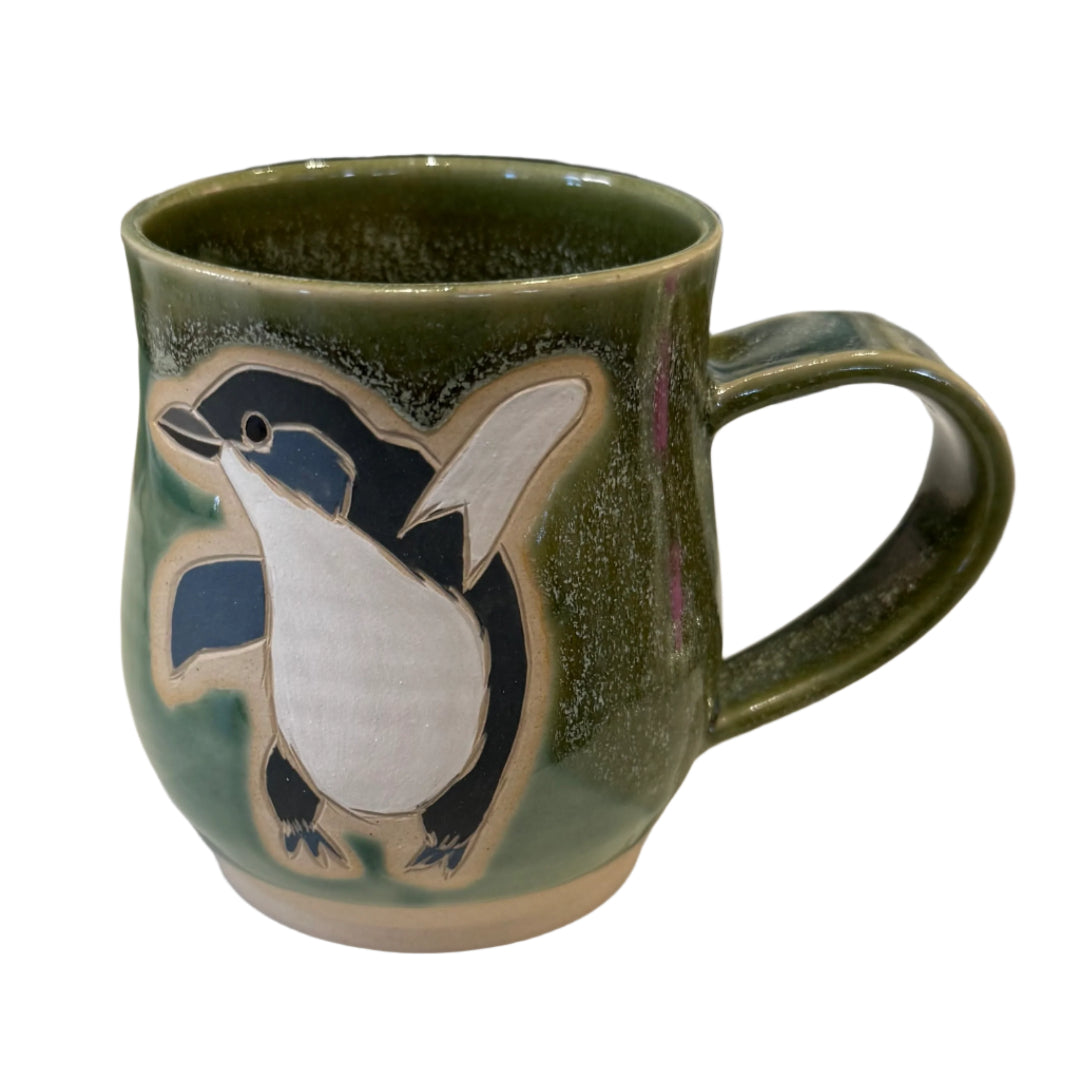 Green Ceramic mug with a Penquin  design on a white background