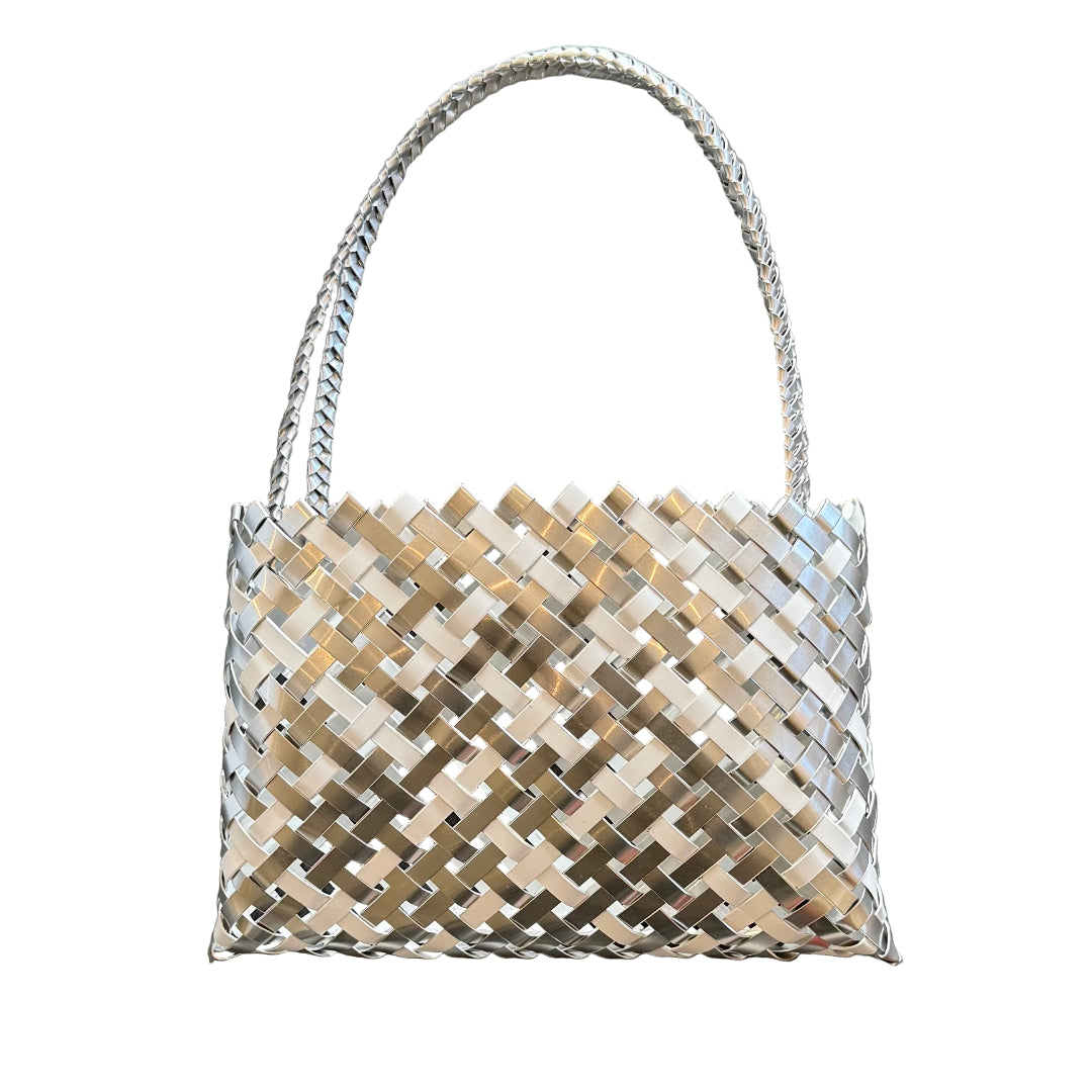 Maori Kete handbag woven with silver and white aluminium on a white 
background