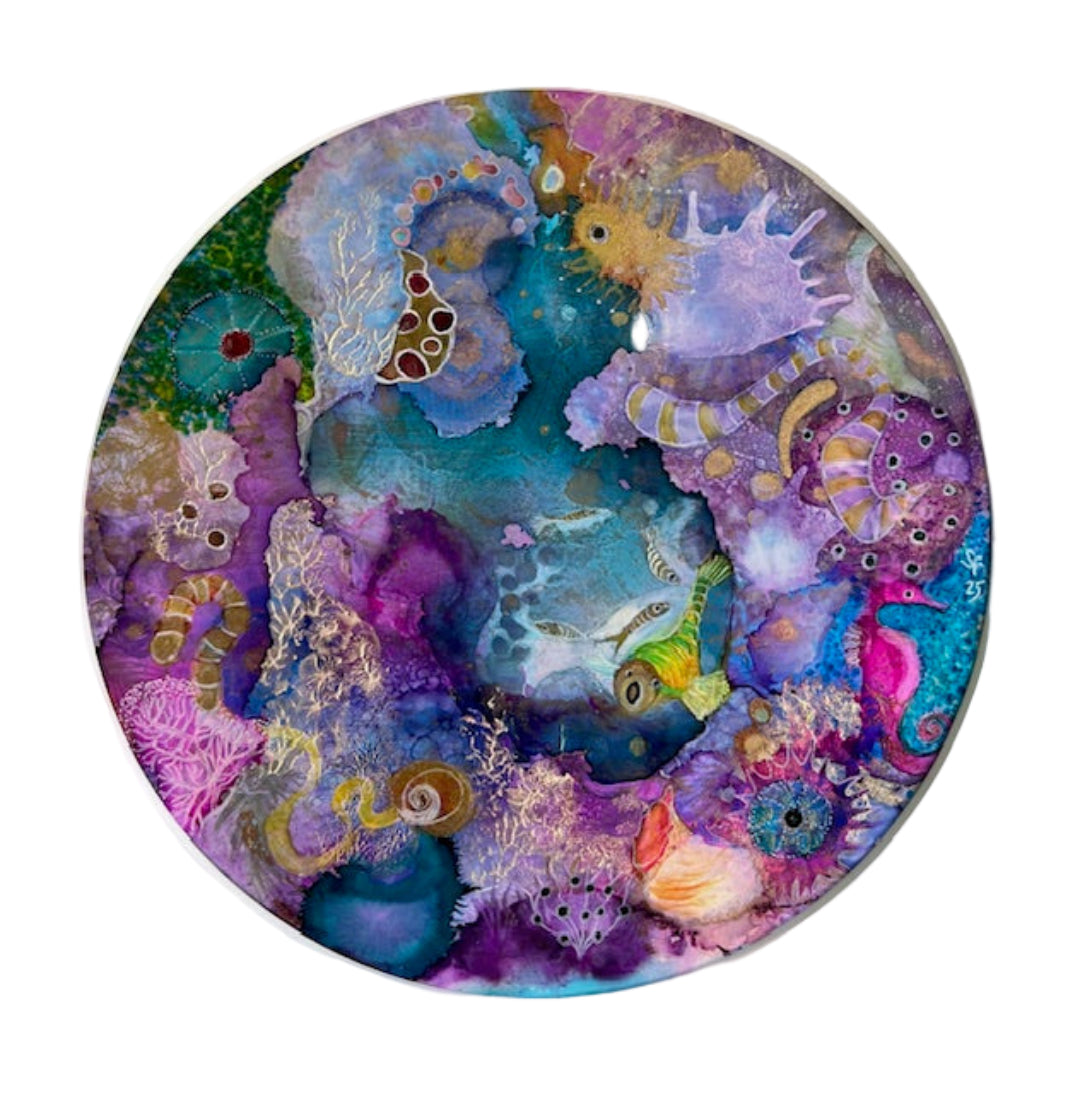 Colorful underwater scene with sea creatures on a circular painting.