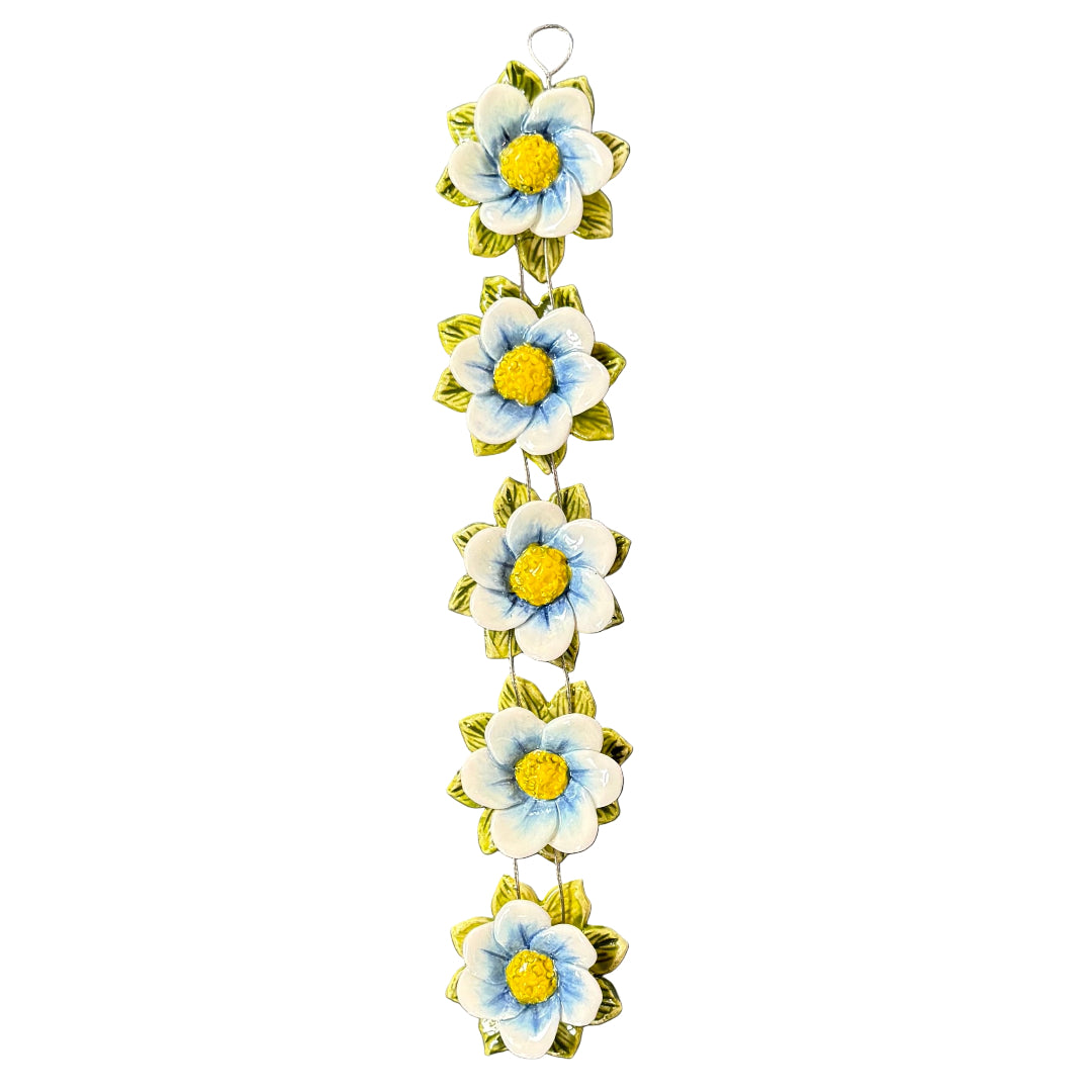 Decorative wall hanging with ceramic blue and white flowers on a white background
