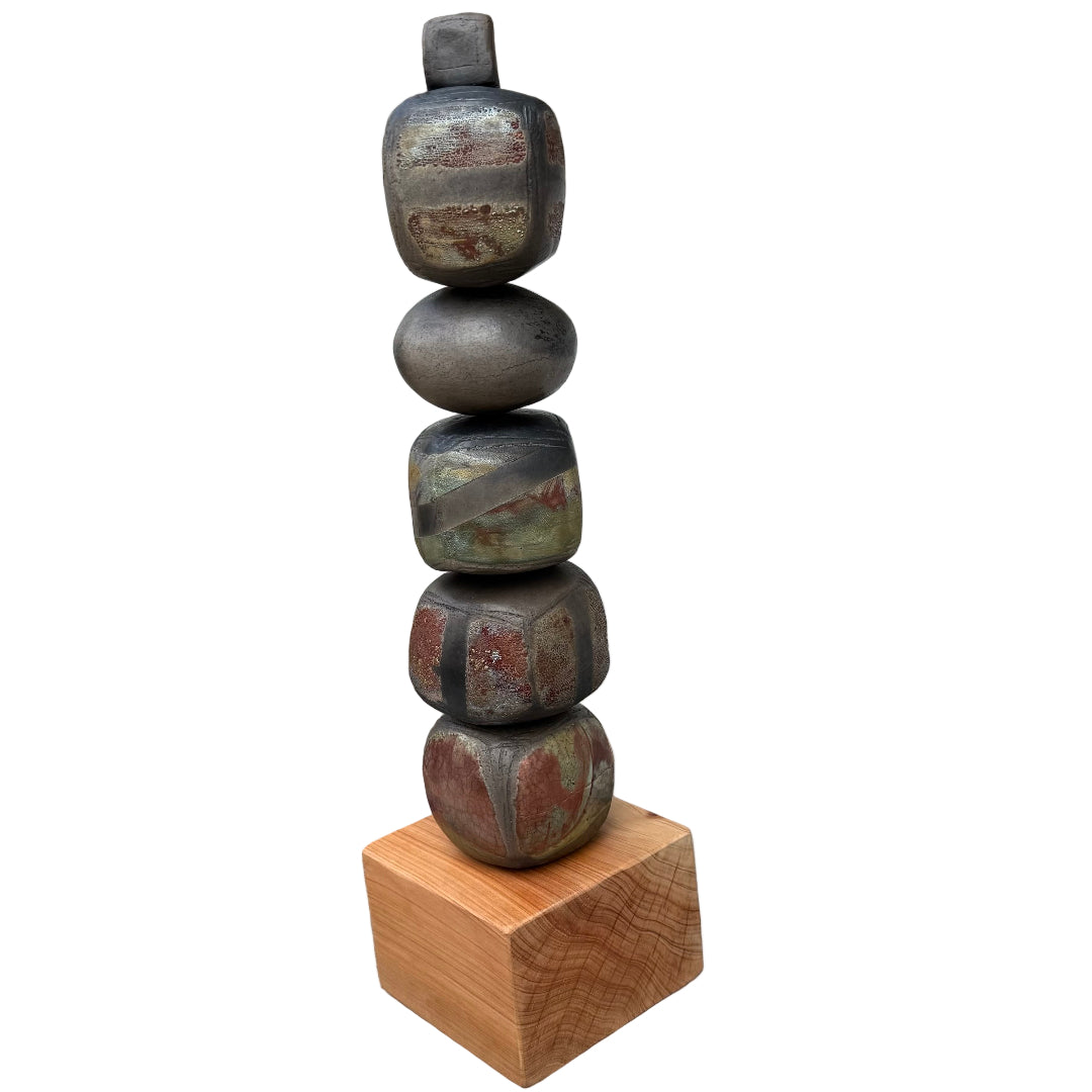 Stack of raku fired ceramic stones on a wooden block