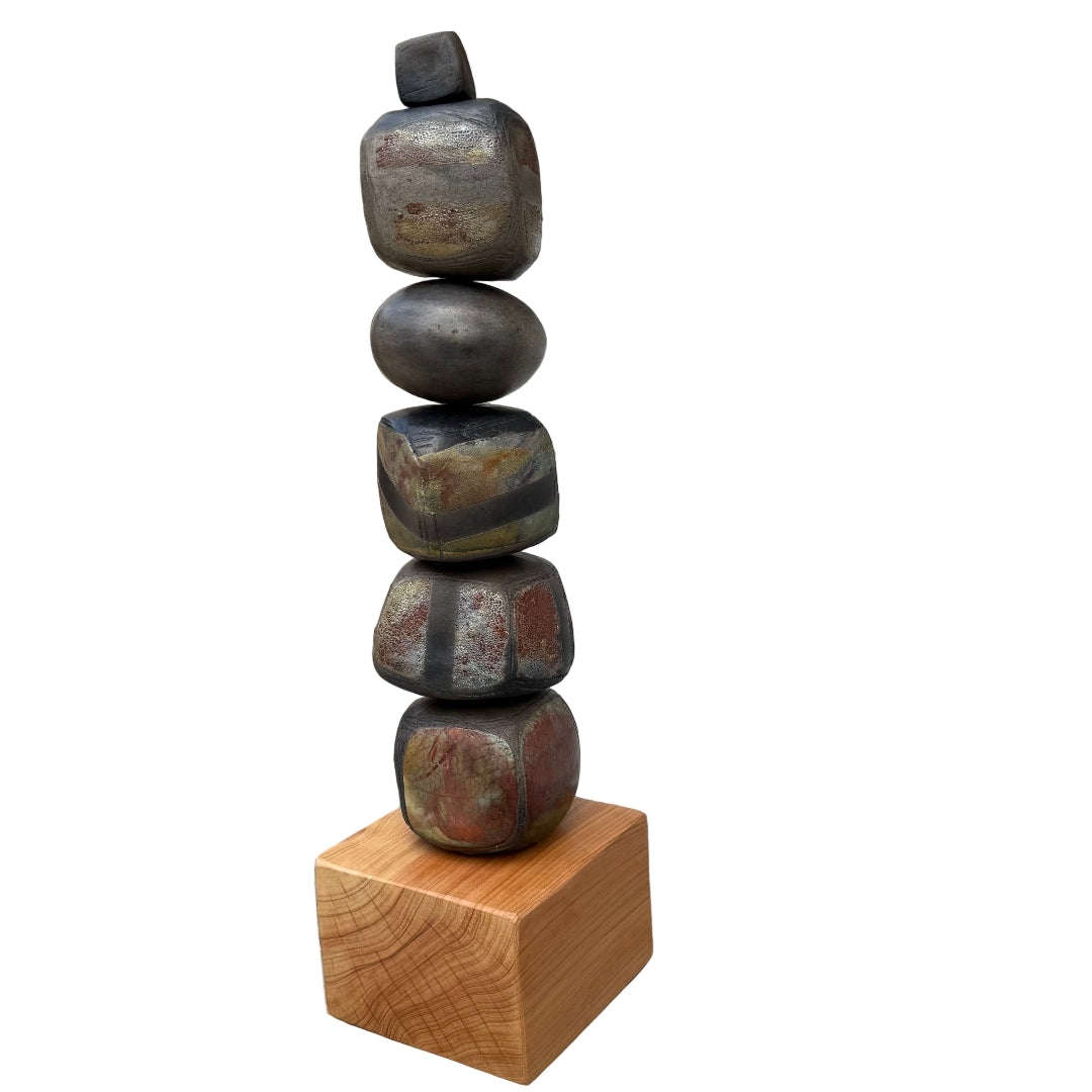 Stack of raku fired ceramic stones on a wooden block