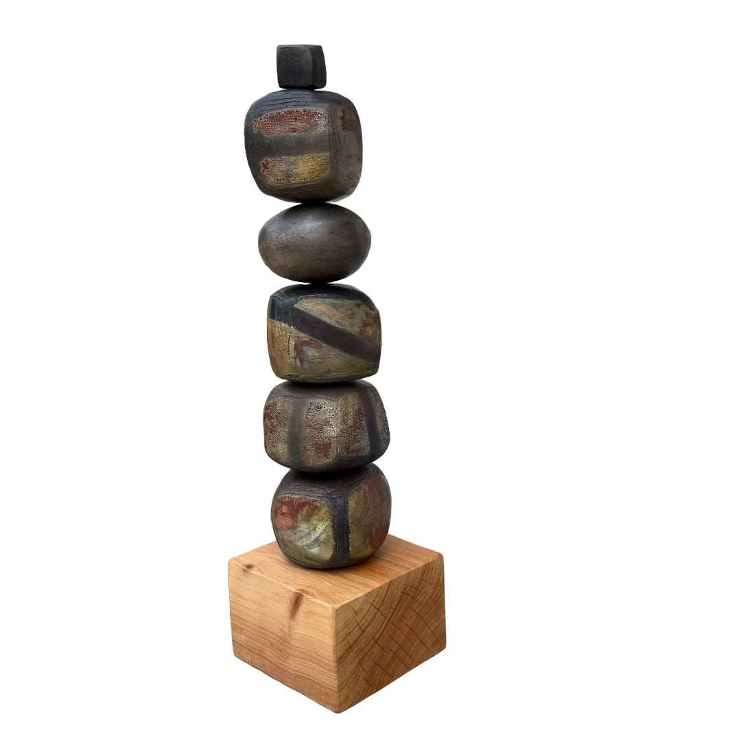 Stack of raku fired ceramic stones on a wooden block