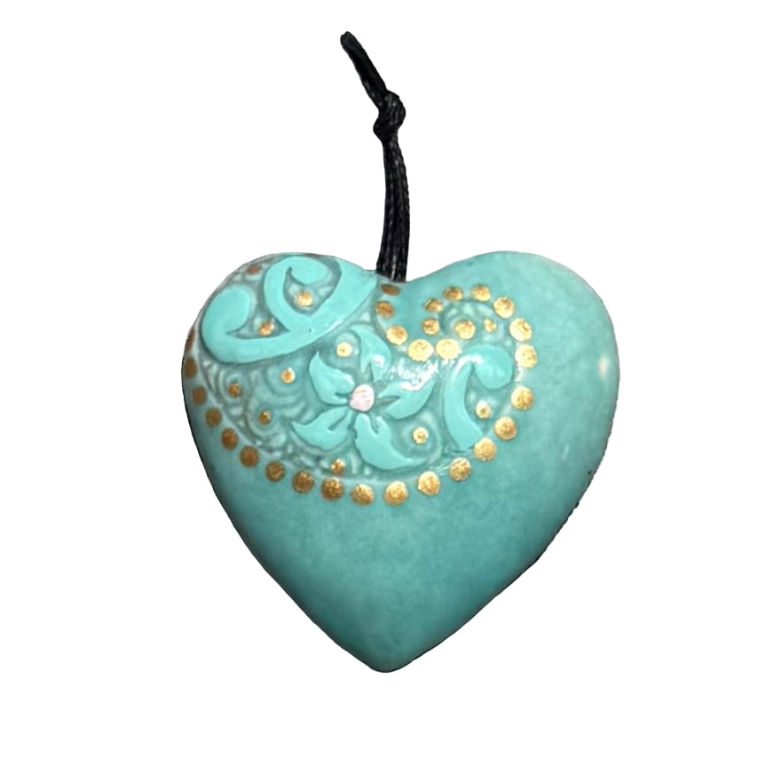 Turquoise ceramic hanging heart with gold embossing on a white surface