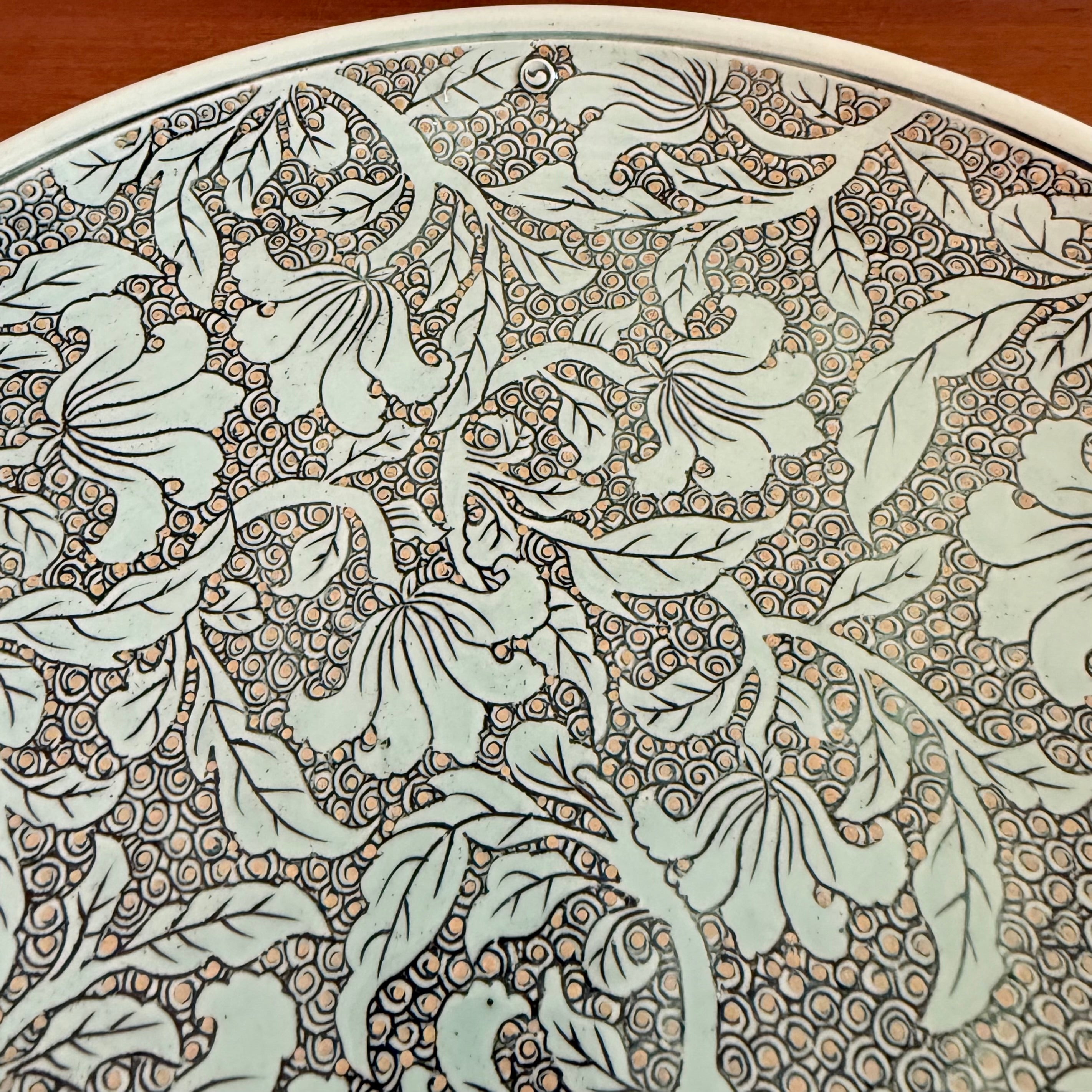Close-up of a decorative paper with floral patterns on a wooden surface