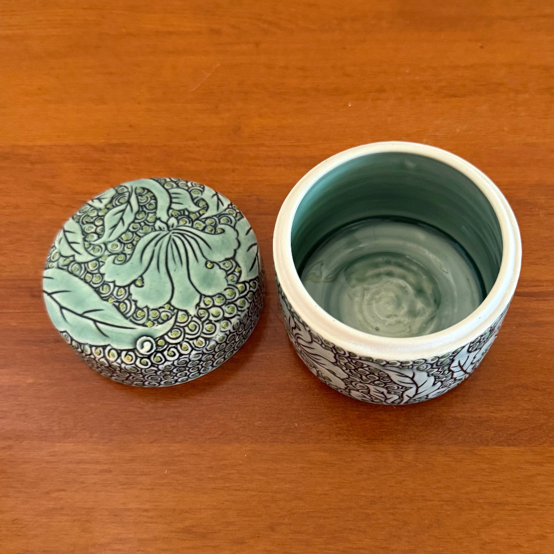 Ceramic container with lid on a wooden surface
