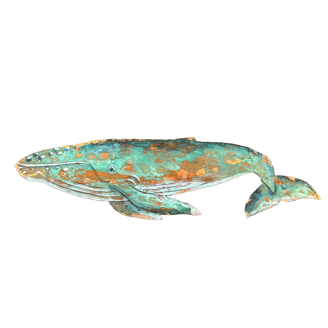 Decorative copper whale sculpture on a white background