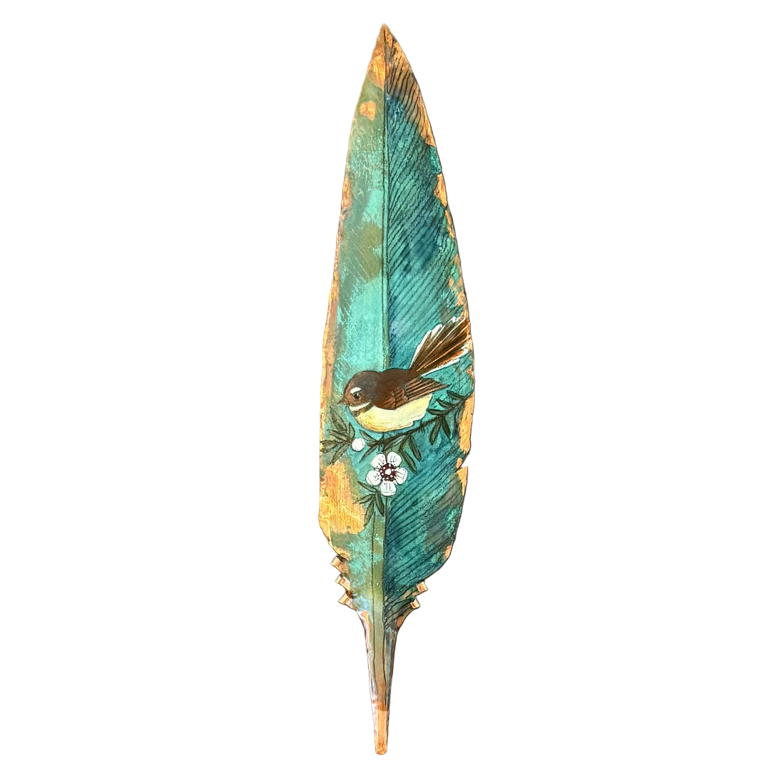 Decorative copper feather with a painted Fantail bird on a white background