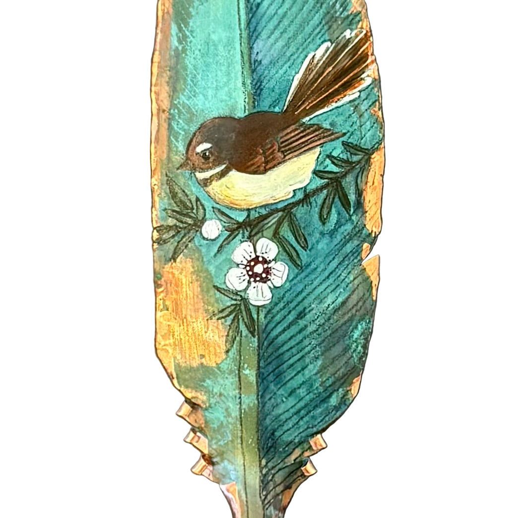 Decorative copper feather with a painted Fantail bird on a white background