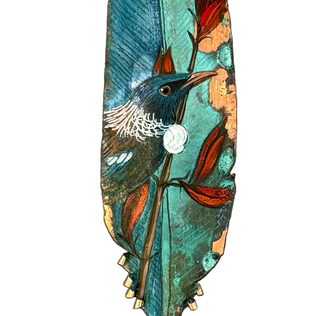 Decorative copper feather with a painted Tui bird on a white background