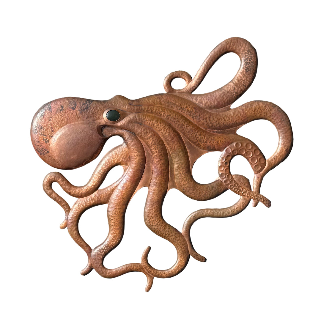 Hand beaten copper octopus sculpture on a white background