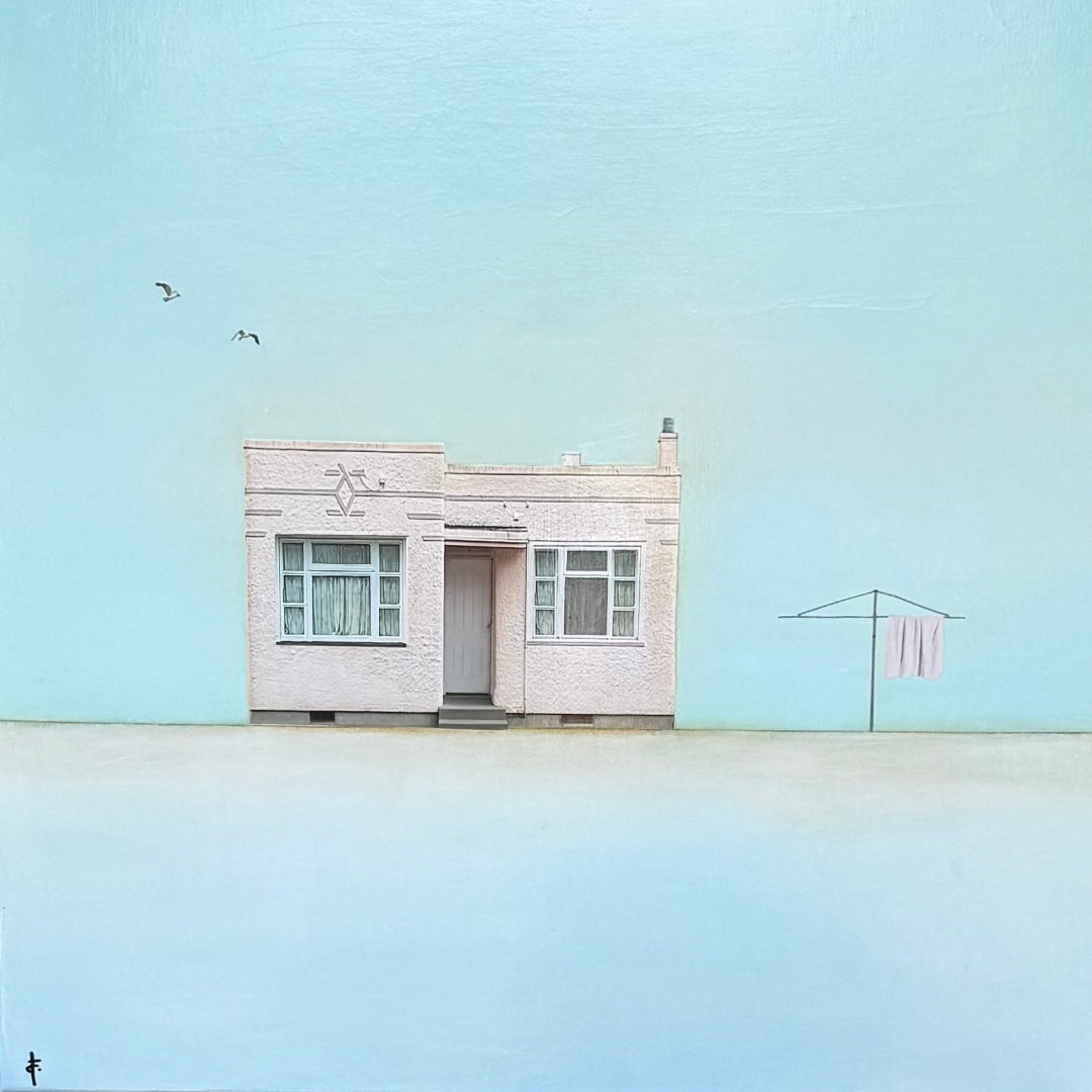 Small house with a clothesline against a light blue sky