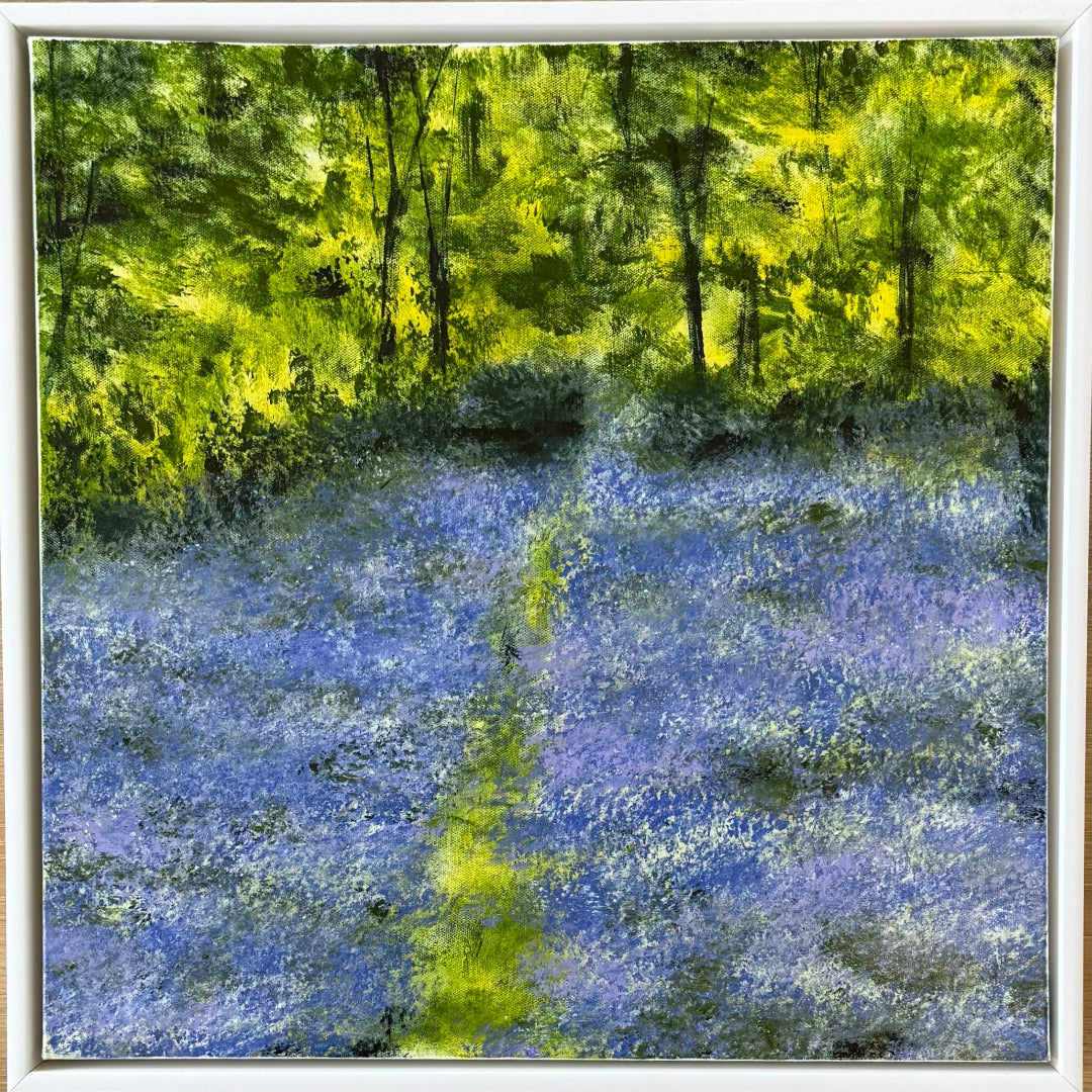 Framed artwork of a forest with blue flowers and green trees