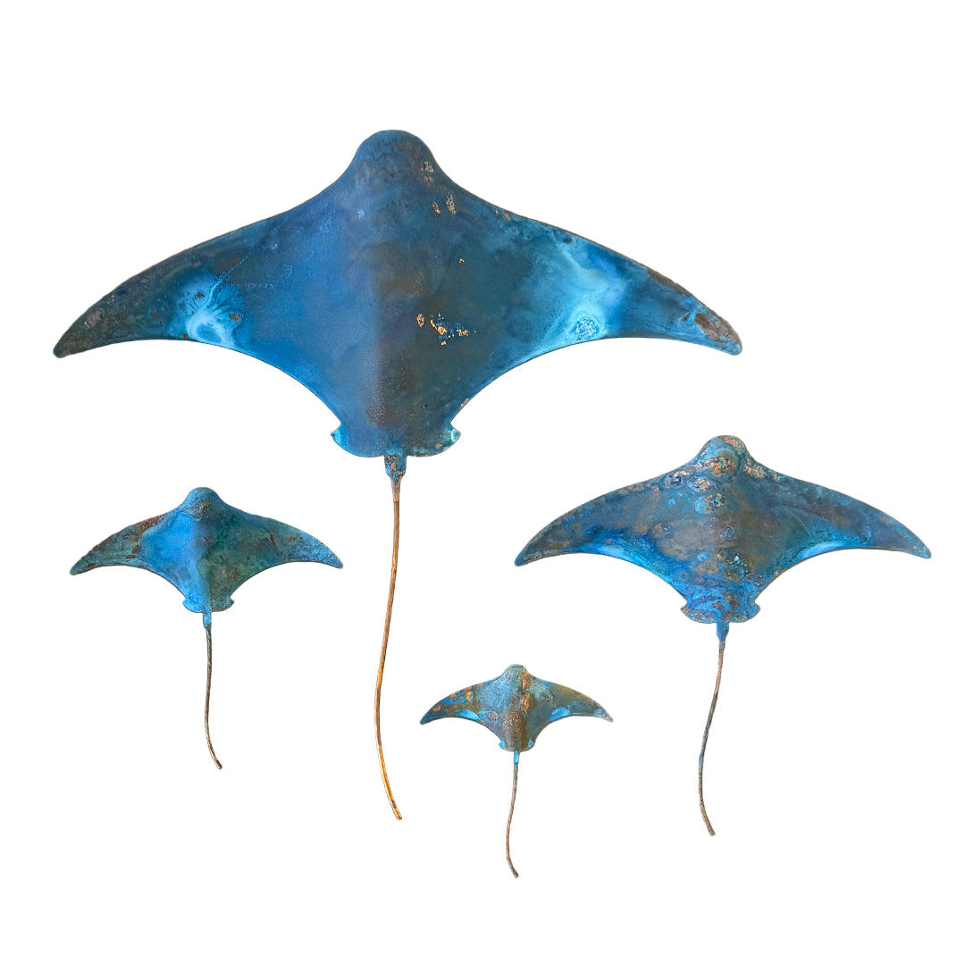 Set of four blue patina'd copper stingrays on a white background