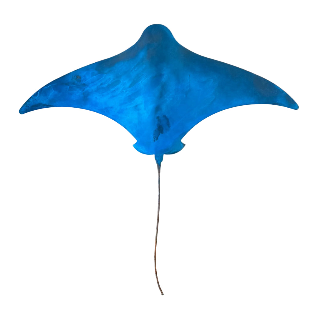 Blue patna'd copper stingray sculpture on a white background