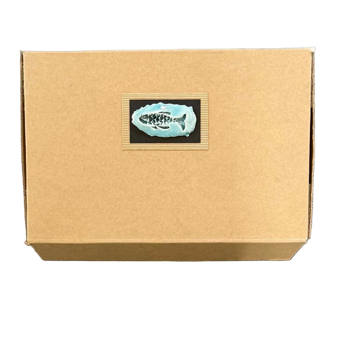 Brown cardboard box with a decorative label featuring a fish on a white background