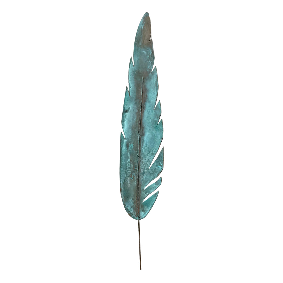 Decorative copper wall feather with green patina on a white background.