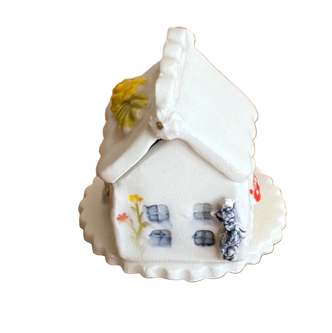 Decorative ceramic trinket box small house with 'Tooth Fairy' text on a white surface