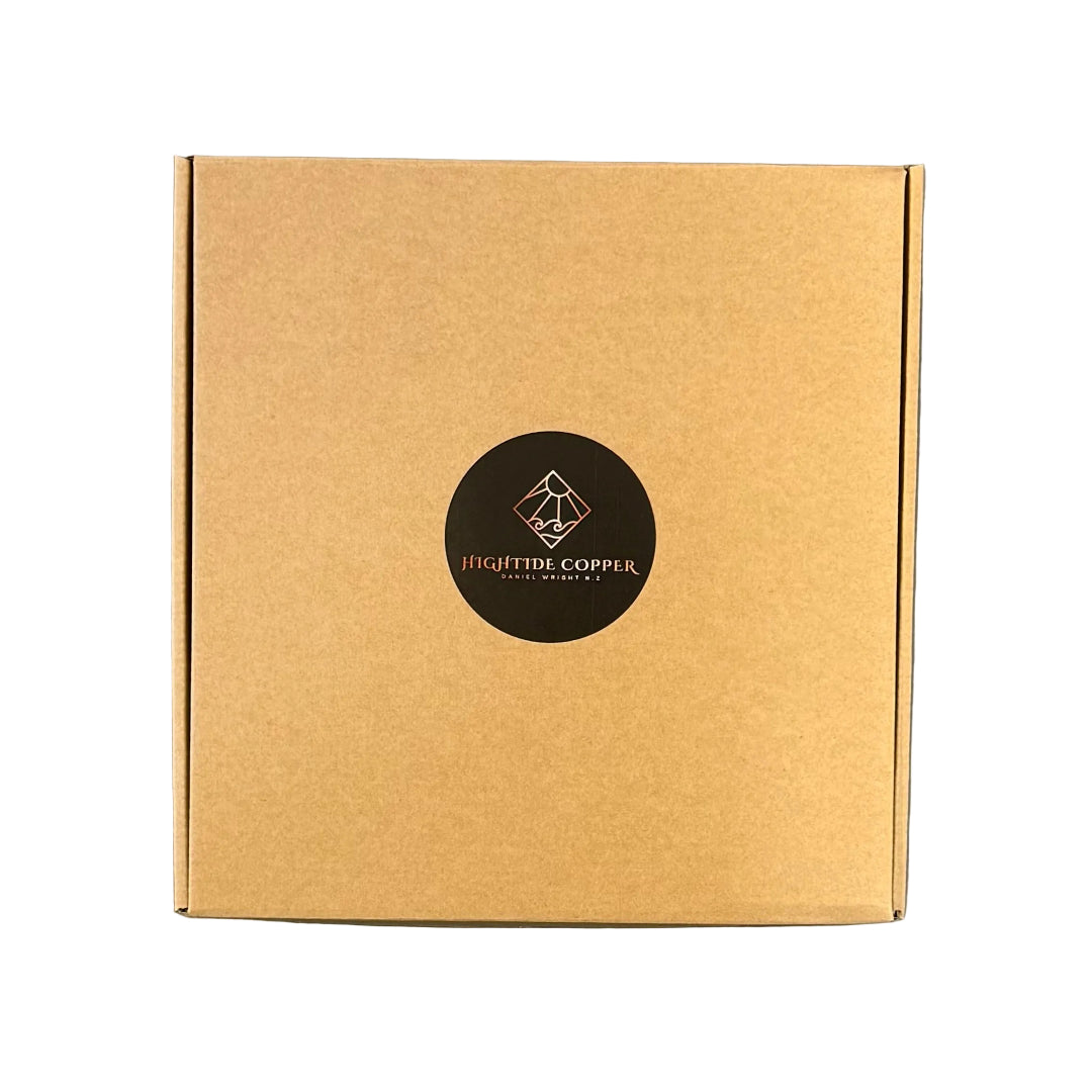 Brown cardboard box with a black circular logo on a white surface