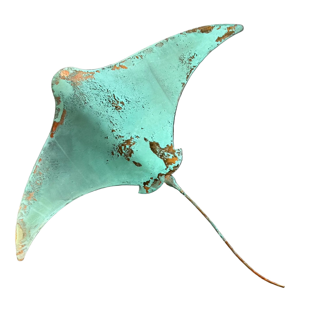 Green patina'd copper wall sculpture of a stingray on a white background