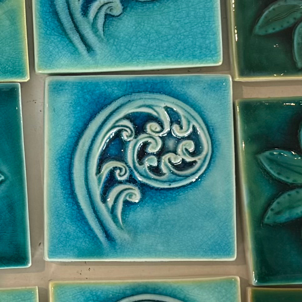 Close-up of blue ceramic tiles with a koru  design